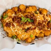 Mojo Tots · Seasoned Tots smothered in our homemade bacon chorizo Spanish sausage gravy topped with smok...