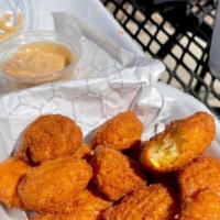 Corn Nuggets · Breaded cream corn, deep fried. Served with a side of chipotle aioli.