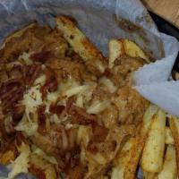 Mojo Fries · Seasoned Fries smothered in our home made bacon chorizo gravy topped with smoked gouda and c...