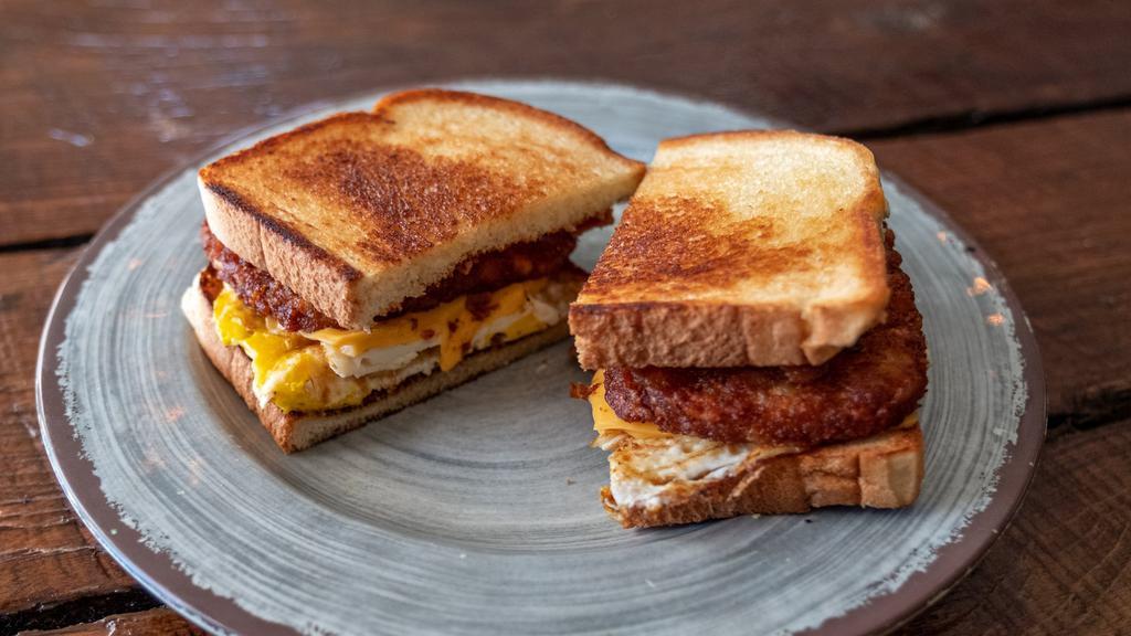 The Greatest · Two fried eggs, two hash brown patties, american cheese, and choice of protein piled high on sourdough bread.