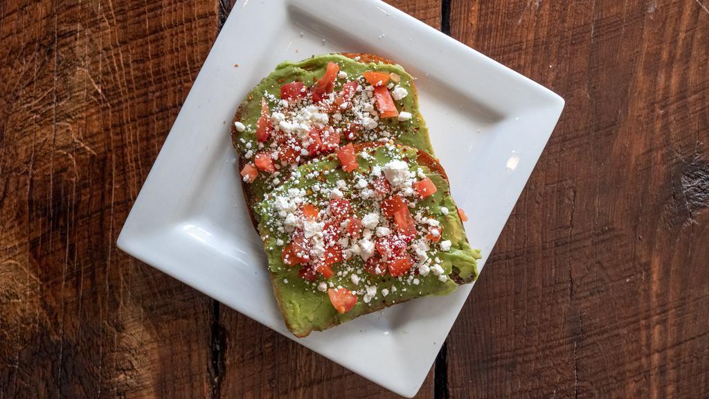 Avocado Toast · Avocado, tomato, goat cheese, and crushed red pepper flakes.  Served open face