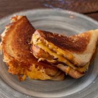 Grilled Cheese · Gooey cheddar jack, mozzarella, and american cheese melted on sourdough.