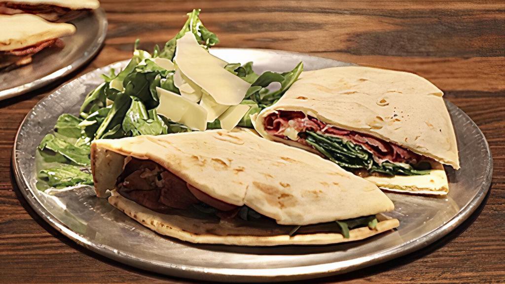 The Dan · Prosciutto, parmesan, and baby arugula  sandwich served with baby arugula and shaved parmesan dressed in extra virgin olive oil and lemon.