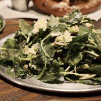 Baby Kale Caesar Salad · Tossed baby kale salad dressed with parmesan, lemon, olive oil toasted croutons, Caesar dres...