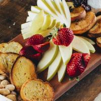 Cheese Board To Go · Selection of 2 regional cheeses served with fruit, nuts, and locally baked bread.