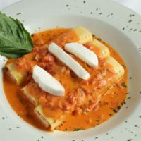 Seafood Cannelloni Gratinati · Pasta filled with ricotta cheese, lobster, scallops, and shrimp in a crabmeat vodka sauce to...