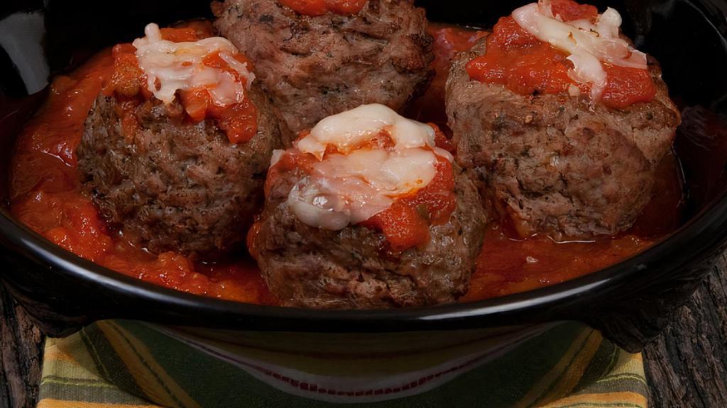 Oven-Baked Meatballs · Four large meatballs baked to perfection, topped with marinara sauce and freshly shredded Mozzarella. Served with hot garlic bread.
