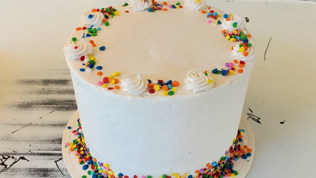 Funfetti Signature Cake · 4 layers of Funfetti Cake, layered with Cream Cheese Frosting & finished with Buttercream and more sprinkles!
