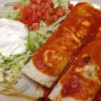 Burritos Supremos · Two burritos, one chicken, one steak with red sauce, and salad.