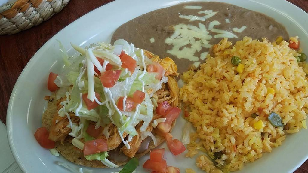 Lunch Tostada · Crispy flour tortilla with choice of chicken or beef. Served with rice, beans, lettuce, tomatoes, cheese, and sour cream.