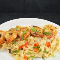 Dusty Trail Alfredo · A rich and creamy blackened Alfredo sauce mixed with tender diced tomatoes and fettuccine (n...