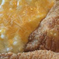 Fish & Grits · Two pieces of flounder, creamy butter grits.