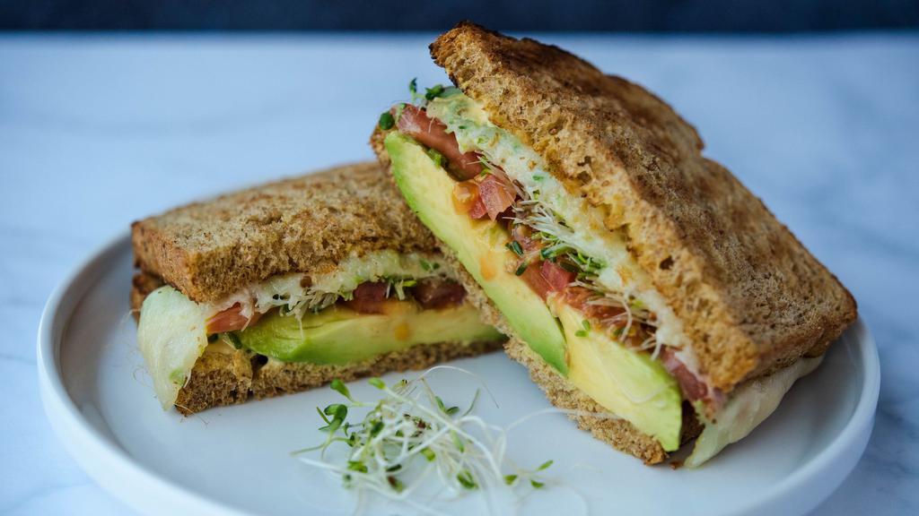 Avocado Melt · Sliced avocado, tomato, spinach, mozzarella cheese, dijonnaise served on toasted Healthgrain bread.  Comes with chips or baby carrots.