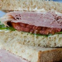 Smoked Turkey Sandwich · Smoked Turkey, lettuce, tomato, mayo served on wheat bread.  Comes with chips or baby carrots