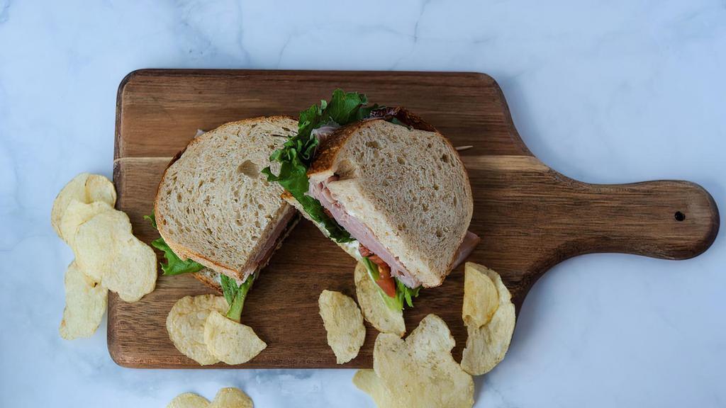 Smoked Ham Sandwich · Smoked ham, lettuce, tomato, mayo served on german sourdough bread.  Comes with chips or baby carrots