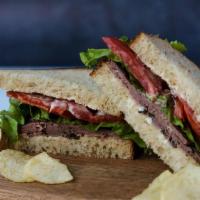 Roast Beef Sandwich · Roast beef, lettuce, tomato, mayo served on german sourdough bread.  Comes with chips or bab...