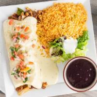 El Grande Burrito · Fajita chicken & steak, Mexican rice, cheese, black beans, caramelized onions & peppers topp...