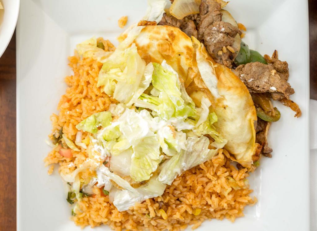 Fajita Quesadilla · Quesadilla with grilled steak or chicken, grilled peppers, onions and cheese. Served with rice or beans, lettuce, tomato, and sour cream.