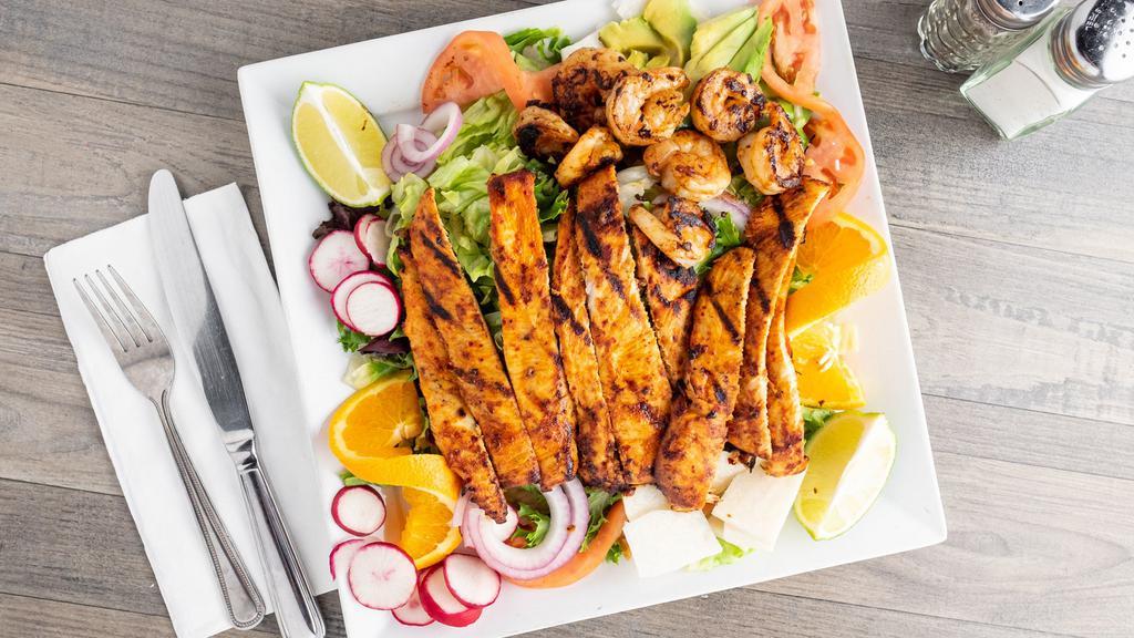 Ensalada Espanola · Grilled chicken breast, served with lettuce, avocado, tomato, and grilled shrimp.