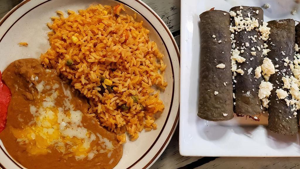 Tacos Fonda · Fried and rolled homemade corn tortillas, two beef and two chicken taquitos with green sauce and sour cream. Served with rice and beans.