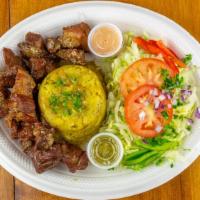 Mofongo De Came Frita · Mashed green plantain with garlic mojito and pork crackling served with fried pork chunks.