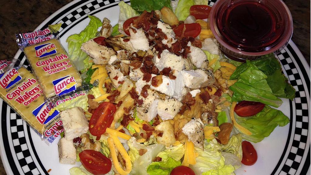 Grilled Chicken Salad · Lettuce, tomatoes, chicken breast, cheddar, bacon & walnuts.