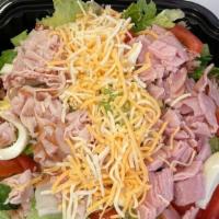 Chef Salad · Bed of romaine lettuce topped with tomatoes, eggs, ham, and turkey with blended cheeses. Ser...