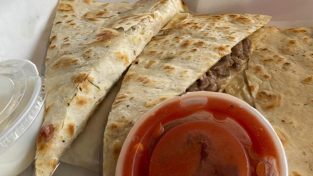 Cheesesteak Quesadillas (New) · A garlic herb tortilla filled with shredded angus beef or chicken, bell peppers, onions, mushrooms, and queso dip. Served with sour cream and Picante sauce.