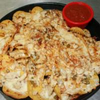 Nachos Supreme · Gluten free corn tortilla chips, topped with seasoned beef or fajita chicken, baked with pep...