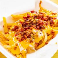 Whodat Fries · Bacon, shredded cheese, nacho cheese, and ranch dressing.