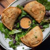 Natchitoches Meat Pies · Crispy fried meat pies served with Cajun ranch for dipping.