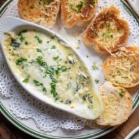 Spinach And Artichoke Dip · A creamy blend of spinach and artichokes, topped with melted Mozzarella cheese and served wi...