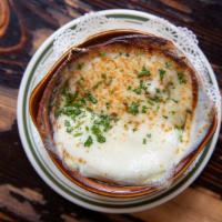 French Onion Soup · A rich broth with smothered onions topped with a crispy crouton and melted Swiss and provolo...