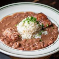 Red Beans & Rice · Creamy, slow-cooked red beans served with white rice, topped with andouille and alligator sa...