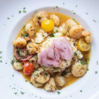 Gulf Shrimp & Grits · Gulf shrimp lightly sautéed in white wine and butter with heirloom tomatoes, shallots, fresh...