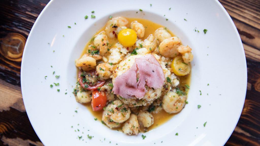 Gulf Shrimp & Grits · Gulf shrimp lightly sautéed in white wine and butter with heirloom tomatoes, shallots, fresh herbs and Chisesi's ham served over our creamy cheese grits.