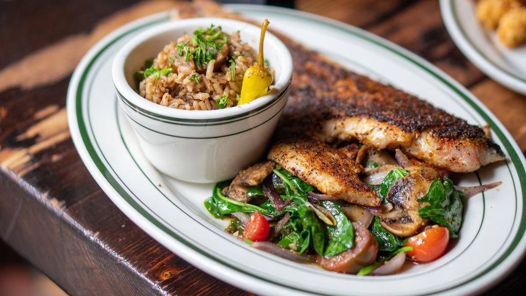 Blackened Redfish · Fresh Louisiana red drum, blackened with cajun spices, served with two sides of your choice.