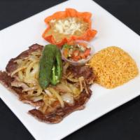 Carne Asada · An 8oz Rib-Eye Steak / Grilled With Onions / Served With Chile Toreado / Refried Beans / Ric...