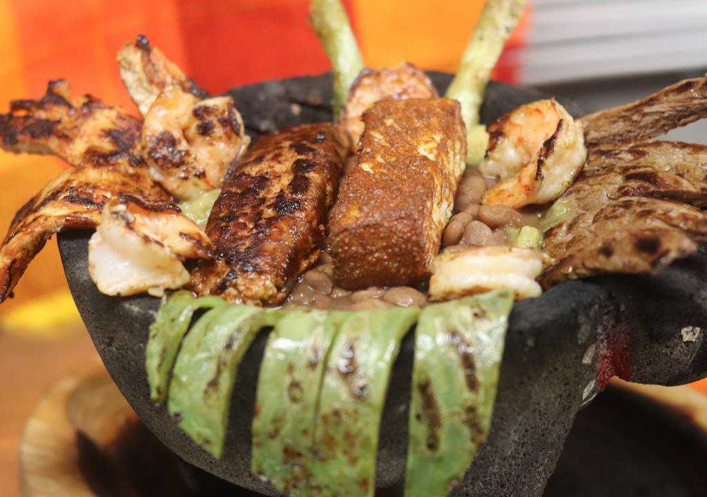 Molcajete · A Complete Parrillada 4oz Grilled Rib-Eye / Grilled Chicken Breast / Chorizo (Mexican Sausage) / Six Grilled Shrimp / Chicharrones (Fried Pork Skins) In Green Tomatillo Salsa / Nopal (Cactus) / Queso Fresco / Green Onions / Whole Pinto Beans & Three Homemade Corn Tortillas.