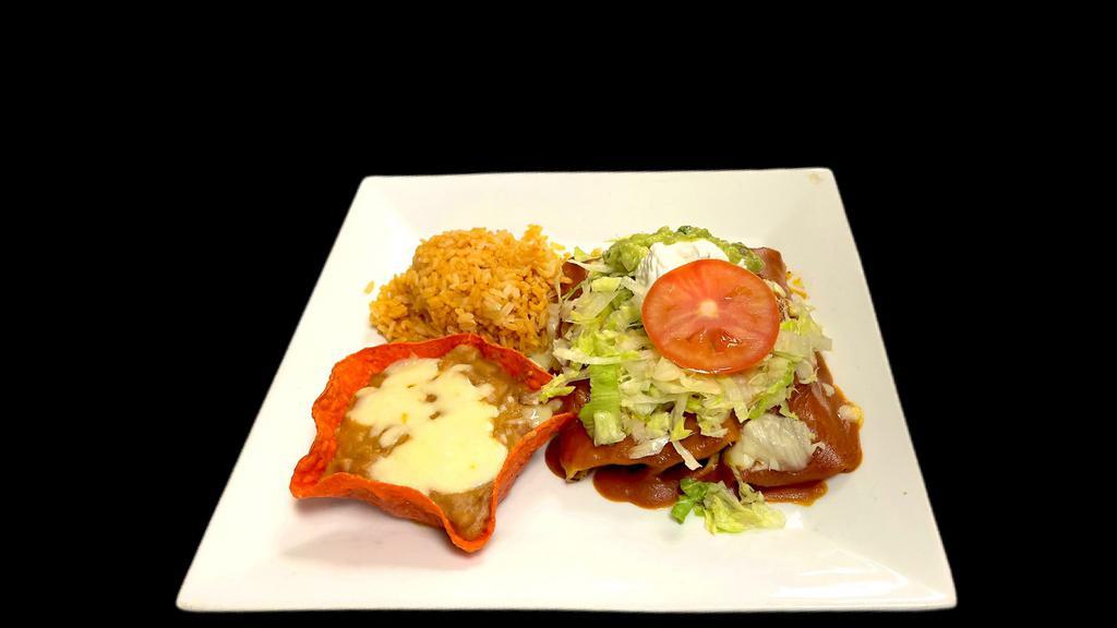 Enchiladas Mexicanas · Three Chicken Enchiladas / Topped With Enchilada Sauce / Cheese / Lettuce / Sour Cream / Guacamole / Tomato / Served With Rice & Refried Beans.