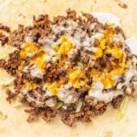 Steak Taco · 1  Chopped philly steak wrapped in a tortilla shell  with banana Peppers, onions, cheese and...