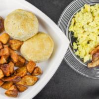 Nirvana Original Breakfast · 4 bacon, bowl of grits, 2 sausage, 3 eggs, 2 biscuits, breakfast potatoes.