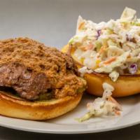 Carolina Patty · 1/4 lb angus patty topped with homemade chili, southern slaw, house dill pickles, mustard an...