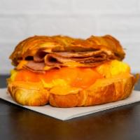 Croissant, Ham, Egg, & Cheddar Sandwich · 2 scrambled eggs, melted Cheddar cheese, sliced ham, and Sriracha aioli on a warm croissant.