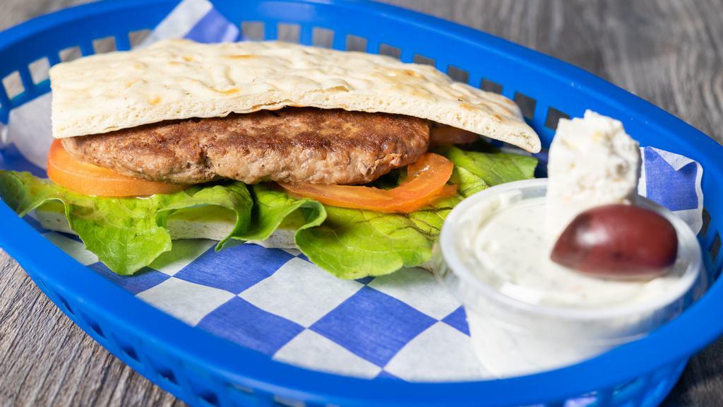 Lamb Burger · Domestic seasoned lamb with romaine lettuce, and tomato with homemade tzatziki served on a warm pita.