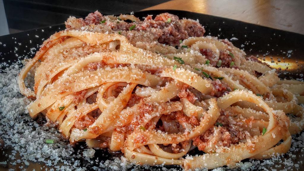 112 Fettuccine Al Ragu' Alla Bolognese · Meat sauce (ragu'), beef, tomatoes, carrots, celery, onions, black pepper, Extra Virgin Olive Oil, topped with imported Parmigiano cheese