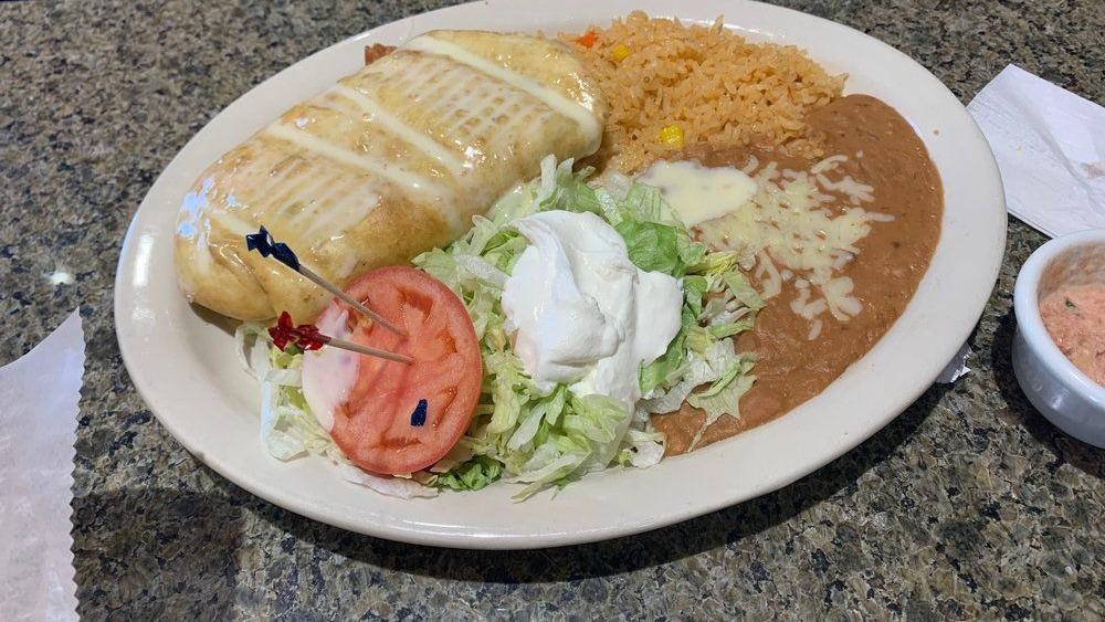 Fajita Chimichanga · With choice of meat.  Fried flour tortillas stuffed with bell peppers, onions and cheese.  Topped with lettuce, tomatoes, guacamole and sour cream.  Served with rice and beans.