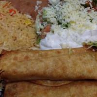 Flautas  · Two flute-like tacos fried, filled with shredded chicken.  Topped with lettuce, guacamole an...