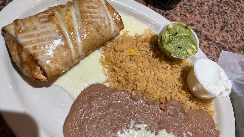 Martinez Enchiladas  · Two enchiladas stuffed with cheese and topped with pork and chipotle sauce.  Served with rice and beans.