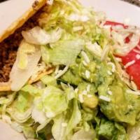 Taco Salad  · With choice of meat.  A lunch-sized fried tortilla filled with cheese and sour cream.